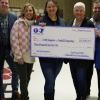 Teacher receiving big grant check