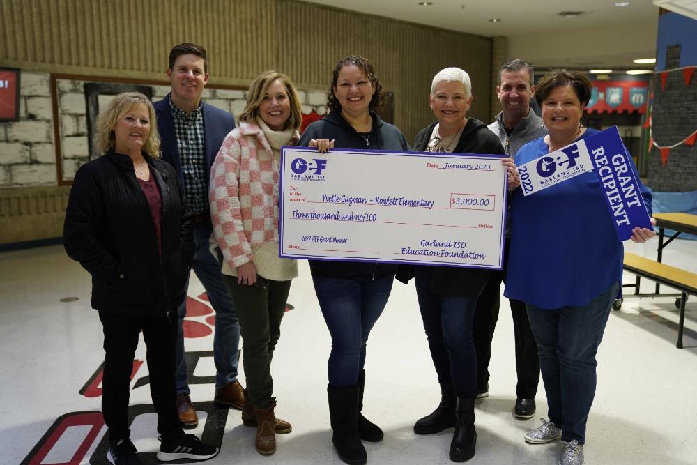 Teacher receiving big grant check